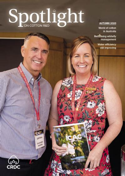 Two people at the ICAC Conference, holding the ICAC conference booklet.