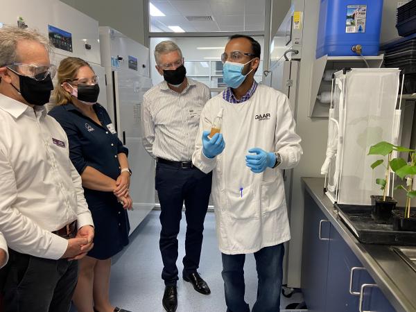Researcher demonstrates technology to group of people in lab.
