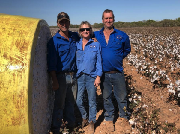 Nick Black, Maya Black and Steve Black stand with one of the many bales of cotton grown on their their station