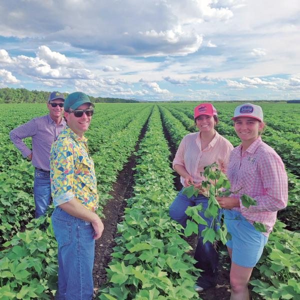 Central Highlands’ growers George Sypher and Max Vowell from Cowal Agriculture, with NRG Ag’s Avanell Morawitz and Clementine Morawitz taking a close up of cotton in the Ord on a trip made possible through CRDC’s Grassroots Grants.