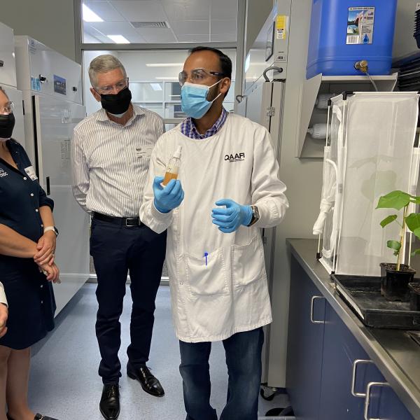 Researcher demonstrates technology to group of people in lab.