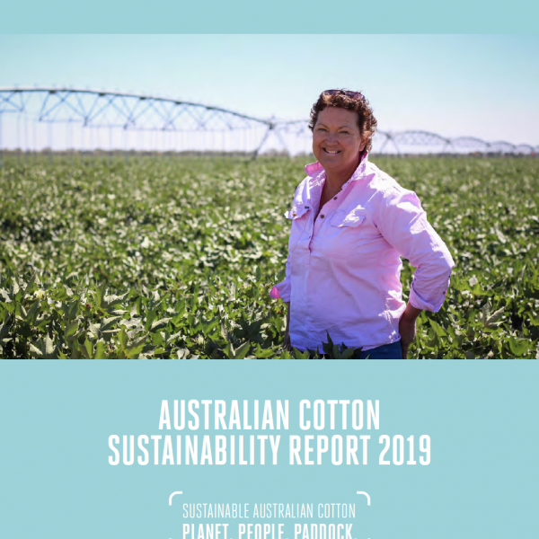 Woman standing in front of an center pivot irrigation system