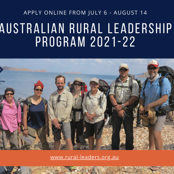 7 people on pebbly shore